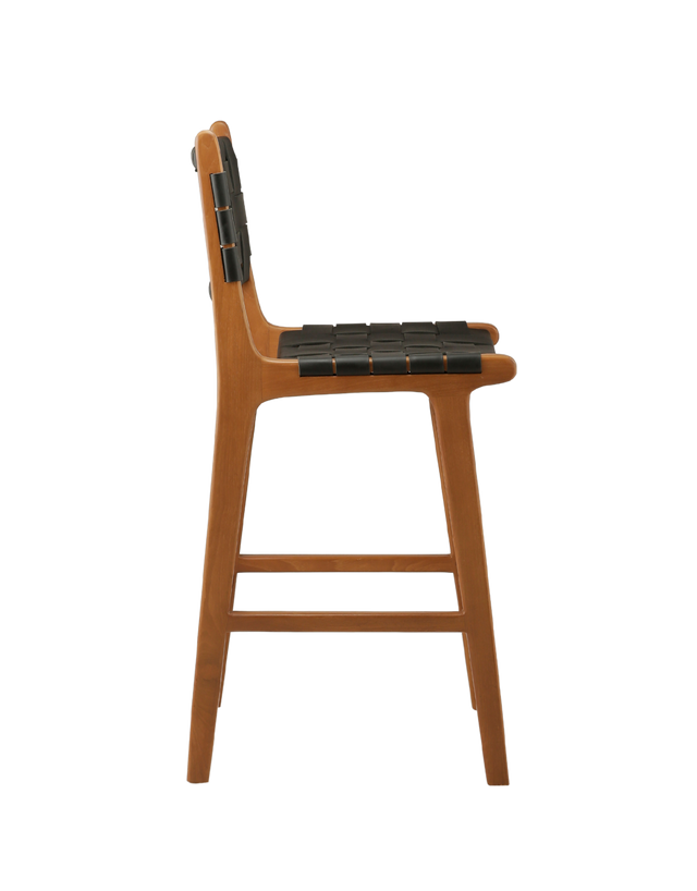 SIde View. A wooden counter stool with a woven black leather seat and back, shown against a transparent background.
