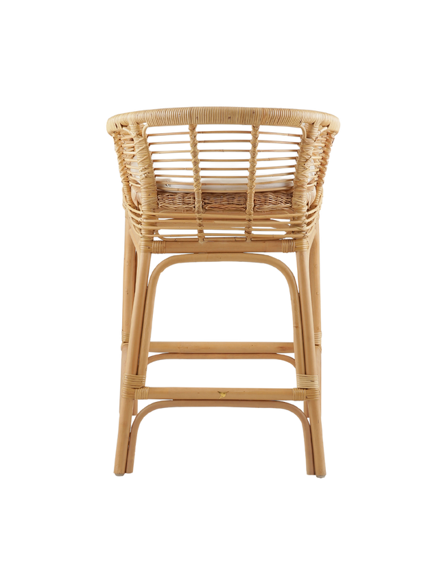 Back View. comfortable counter stool made from rattan, featuring a woven seat and backrest with armrests. The stool has a cushioned seat for added comfort and a natural rattan frame with intricate weaving. Its relaxed yet stylish design makes it a perfect fit for modern or coastal-inspired interiors. 3/4 view of the stool