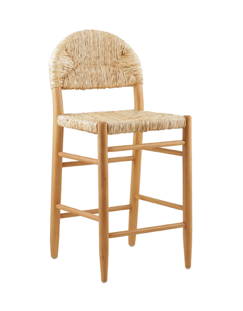 A rustic counter stool featuring a woven natural rattan seat and backrest with an arched design. The counter stool has a sturdy wooden frame in a light finish, complete with footrests for added comfort and support. 3/4 view of the counter stool