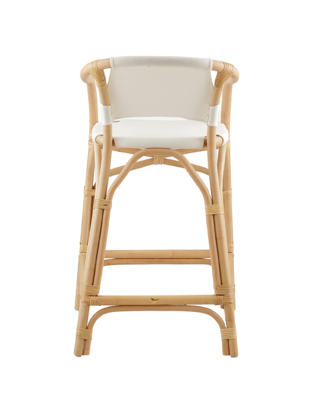 Back View. A natural rattan-style counter stool with a curved frame, white padded seat and back, and woven accents, shown against a transparent background.