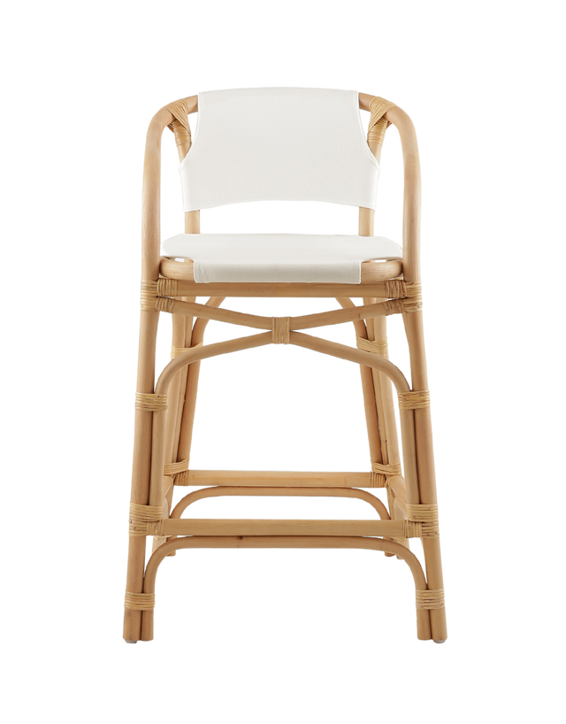 A natural rattan-style counter stool with a curved frame, white padded seat and back, and woven accents, shown against a transparent background.