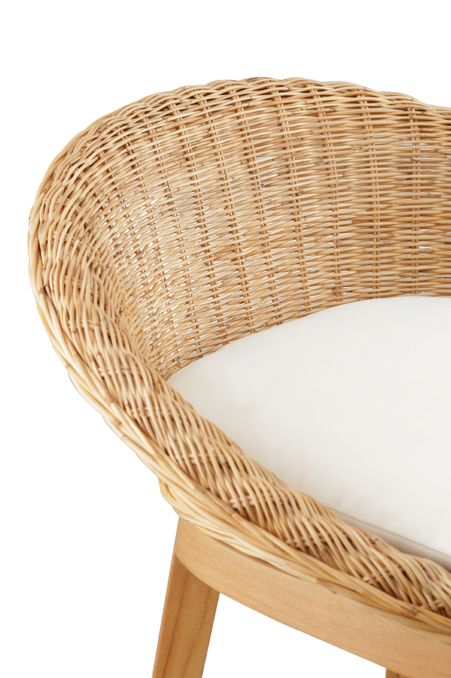 Close up of the weave. cozy counter stool with a round woven rattan seat and a white cushioned cushion for added comfort. The stool features a wooden frame with four legs, offering a natural and rustic look. 