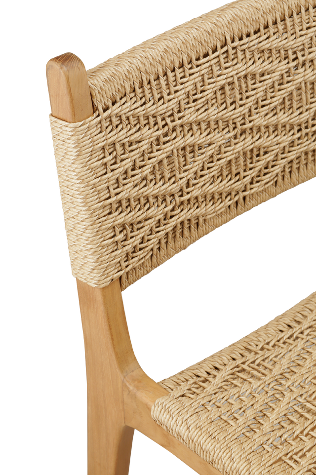 Close up view of the weave. counter stool with a woven rattan seat and backrest. The backrest features a square woven pattern, with the rattan weaving arranged in a grid-like formation. The seat is woven with a slightly curved design, offering a comfortable and stylish look.