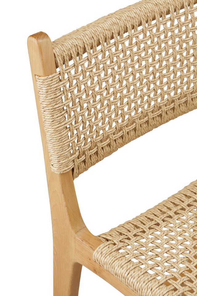 counter stool with a woven rattan seat and backrest. The backrest is woven in a diagonal pattern, creating a more textured, crisscross appearance. The seat features a similar woven style, with a smooth and rounded shape for added comfort. detailed view 