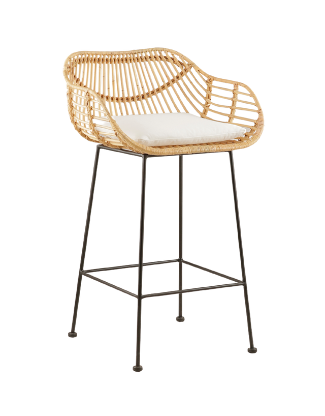 modern counter stool with a rattan seat and backrest, featuring a unique, curved design. The stool has a comfortable white cushioned seat and is supported by slim black metal legs, creating a contrast with the natural rattan. Its contemporary design makes it an ideal choice for stylish, relaxed interiors.