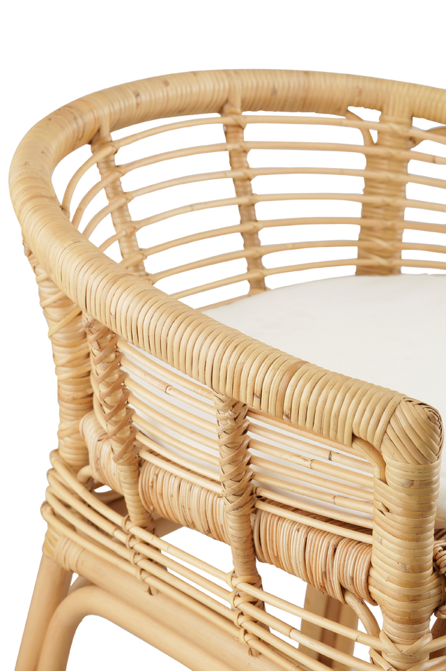 Close up of the materials. comfortable counter stool made from rattan, featuring a woven seat and backrest with armrests. The stool has a cushioned seat for added comfort and a natural rattan frame with intricate weaving. Its relaxed yet stylish design makes it a perfect fit for modern or coastal-inspired interiors. 3/4 view of the stool