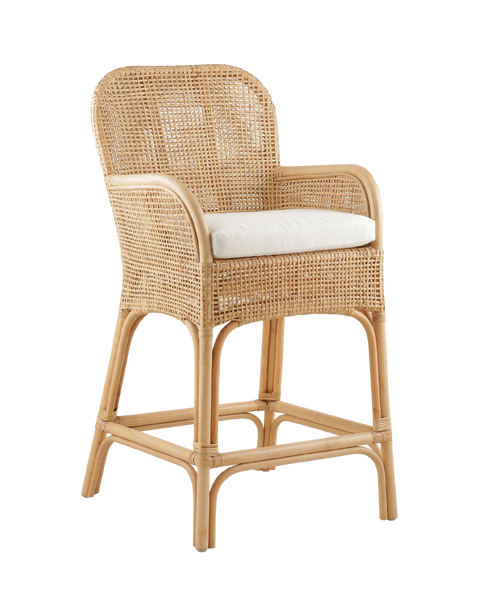 stylish counter stool made entirely from rattan, featuring a woven seat and backrest. The stool includes armrests and a cushioned seat for added comfort. The natural rattan frame is intricately woven, giving the stool a chic, relaxed look, perfect for modern or coastal-inspired interiors.