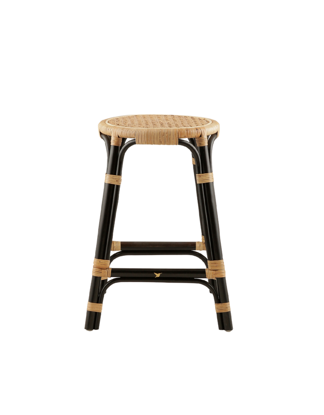 A rattan counter stool with a round woven seat and black frame accented with natural rattan bindings, shown against a transparent background.