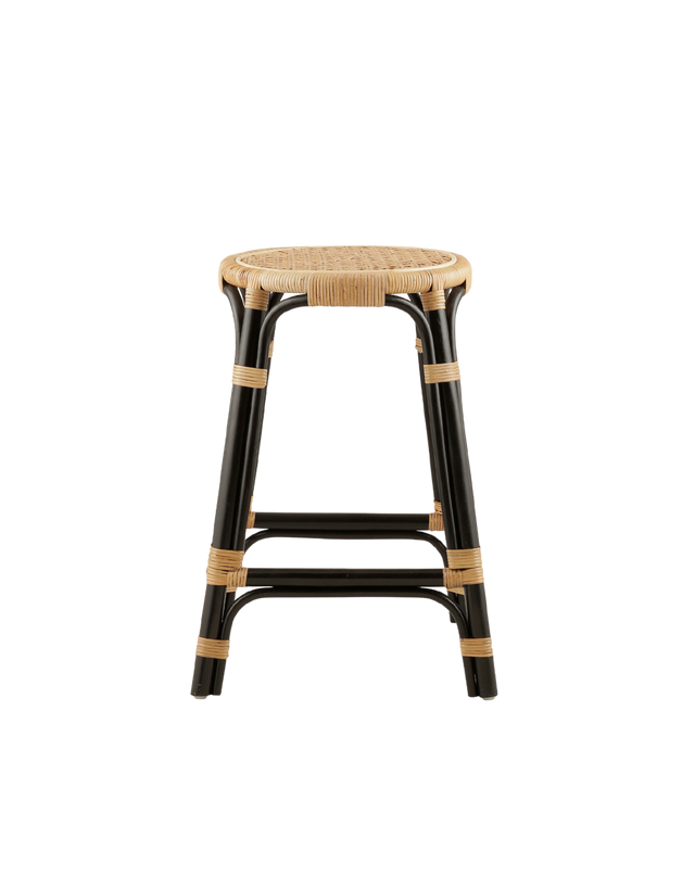 A rattan counter stool with a round woven seat and black frame accented with natural rattan bindings, shown against a transparent background.