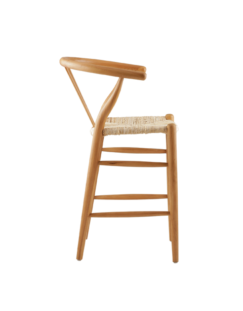 counter stool made from teak wood with a woven seat. The stool features a classic design with a curved backrest and straight legs. The natural wood finish highlights the rich grain of the teak, giving it a timeless, rustic charm. Side view